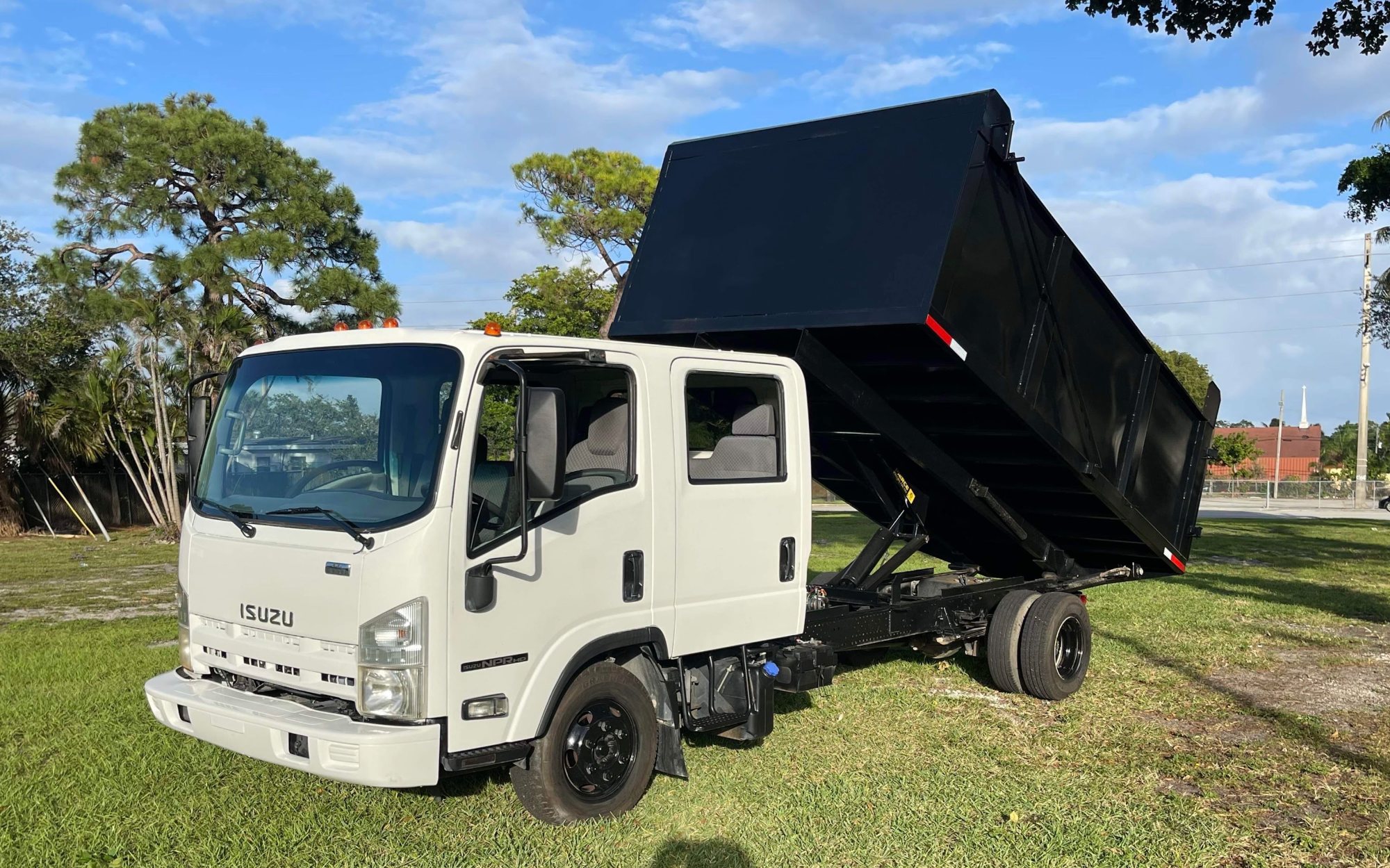 Coral Springs Junk Removal dump truck with the bed raised, ready for a junk removal job in Broward County FL
