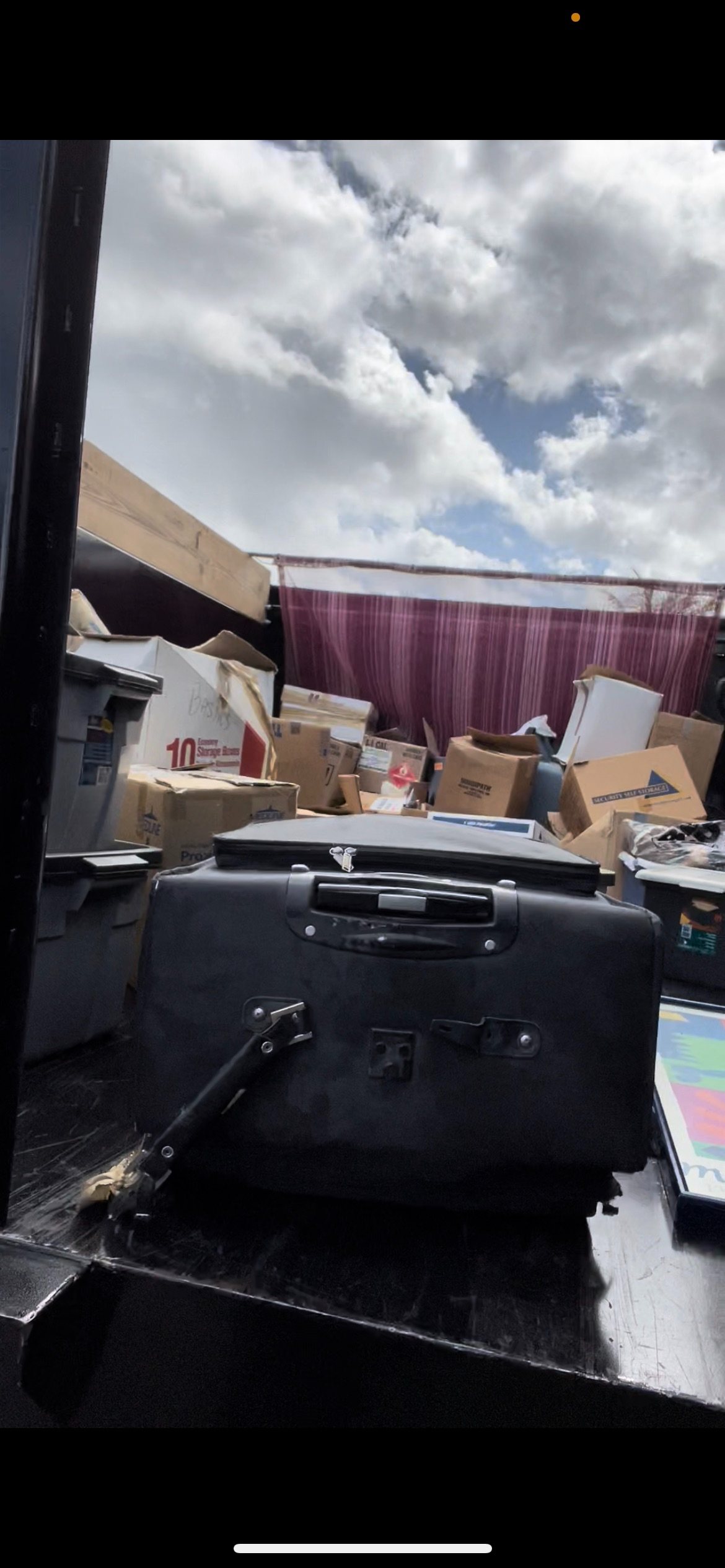 Junk removal truck loaded with boxes and storage unit contents in Broward County FL